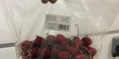 Frozen cherries for sale with stone and stem. The